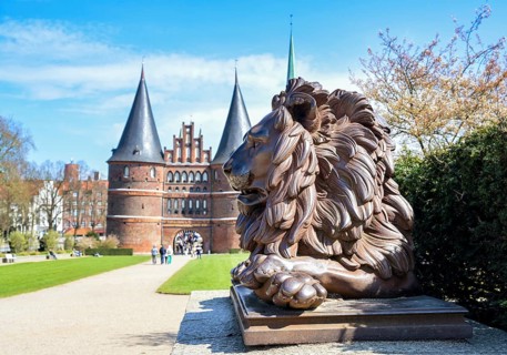 Lion statue from iron guards the Lubeck Holstentor or Holsten gate, historic landmark and tourist