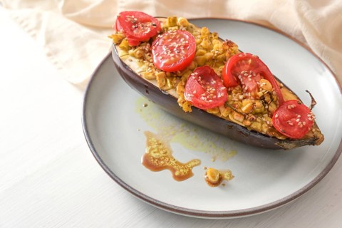 Healthy vegetarian low carb meal, baked eggplant with turmeric, ginger, onions, tomatoes and sesame