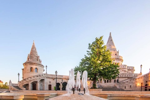 Old historic fortress and church at sunrise. City panorama at dusk. View of the Danube Fishermen's