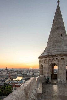 Old historic fortress and church at sunrise. City panorama at dusk. View of the Danube Fishermen's