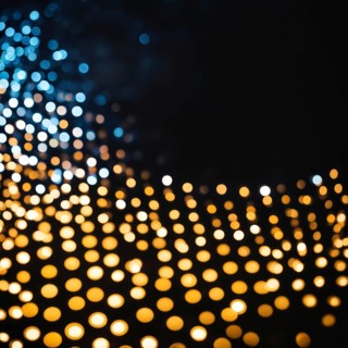 Abstract bokeh effect combining warm-colored and blue lights creating a glowing and patterned