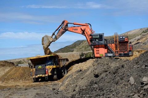 WESTPORT, NEW ZEALAND, MARCH 11, 2015: 190 ton digger loads rock from a layer of overburden at open