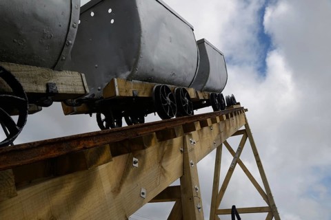 A coal mining memorial at Dobson in New Zealand features vintage coal wagons from an underground