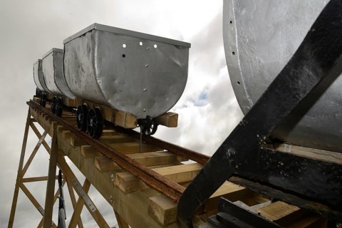 A coal mining memorial at Dobson in New Zealand features vintage coal wagons from an underground