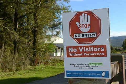 Signage shows that an essential business has restricted access during the Covid 19 lockdown in New