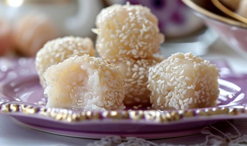 Sweet rice dumplings with sesame filling on a pastel purple plate AI generated