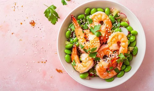 Shrimp and edamame salad with sesame seeds on a light pink background AI generated