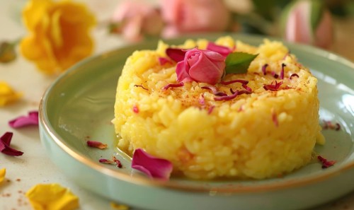 Rose and saffron rice pudding on a pastel green plate AI generated