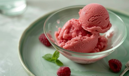 Rose and raspberry sorbet in a glass bowl on a pastel green plate AI generated