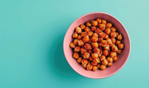 Roasted chickpeas with paprika in a pastel pink bowl AI generated