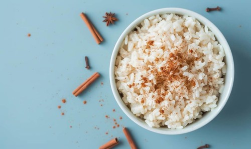 Puerto Rican arroz con dulce with cinnamon on a light blue background AI generated