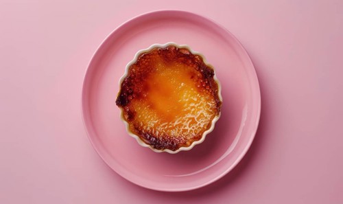Lemon and coffee creme brulee with caramelized top on a pastel pink plate AI generated