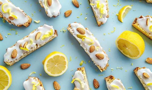 Lemon and almond biscotti with lemon glaze on a light blue background AI generated