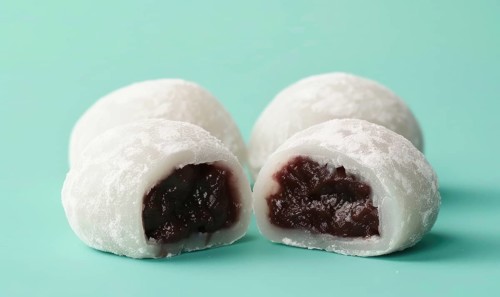Japanese mochi with sweet red bean paste on a light green background AI generated
