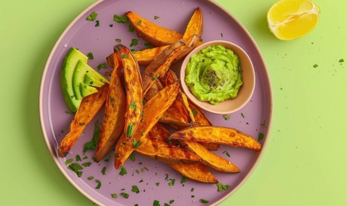 Baked sweet potato fries with avocado dip on a pastel purple plate AI generated