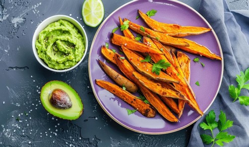 Baked sweet potato fries with avocado dip on a pastel purple plate AI generated