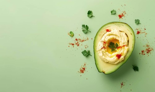 Avocado and hummus dip on a light green background AI generated