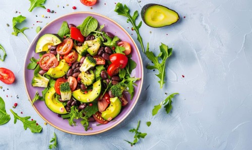 Avocado and black bean salad on a pastel purple plate AI generated