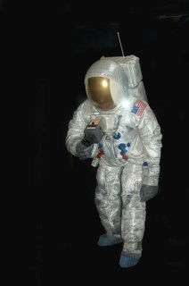 American astronaut in pressure space suit on black background