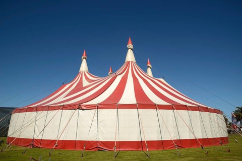 Colourful circus tent against a blue sky