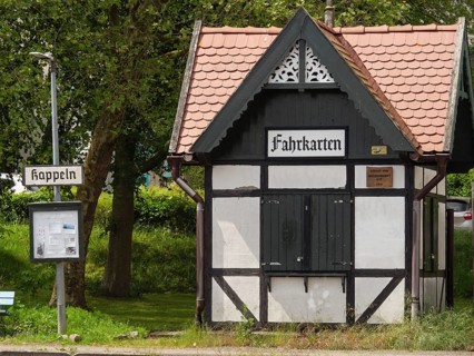 Small half-timbered building with signs and ticket office at an old railway station, Kappeln,