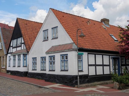 Traditional houses with red roofs and half-timbered houses along the street, Kappeln,