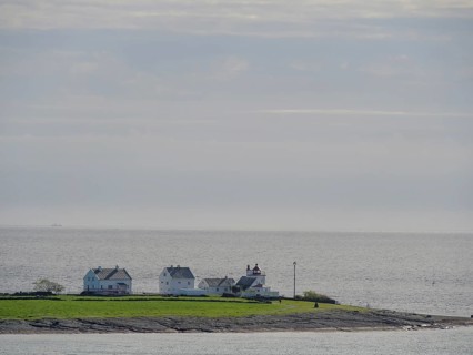 An island with few houses surrounded by the sea under a cloudy sky, Stavanger, Norway, Europe