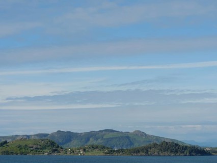 Coastal landscape with a view of the sea and wooded hills in the background, Stavanger, Norway,