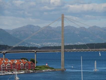Bridge over the sea with mountains and houses with red roofs in the foreground, Stavanger, Norway,