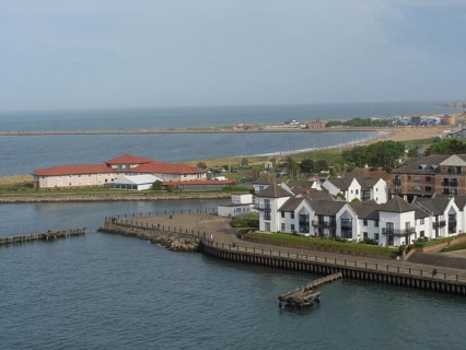 Stretch of coastline with several modern houses and views of the tranquil seascape, Newcastle,