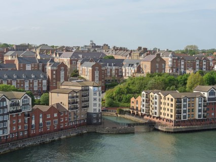 Residential building along a river with a view of the city, Newcastle, England, Great Britain
