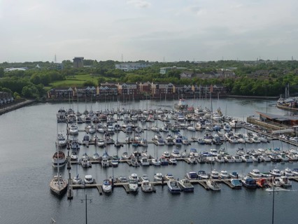 Marina with many boats and neighbouring houses in the background under a cloudy sky, tynemouth,