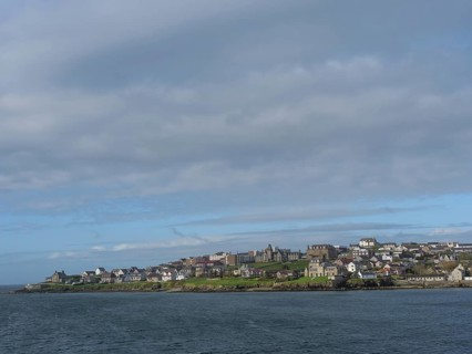 Coastal landscape with houses under cloudy sky and neighbouring sea, Lerwick, Shetlands, Scotland,