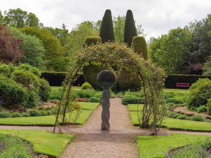 Well-kept garden with lawns, shrubs and a sculpture in the centre, inverness, Scotland, United