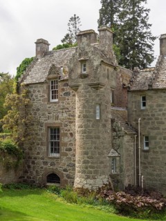 Part of an old castle with towers and stone walls, surrounded by trees, inverness, Scotland, Great