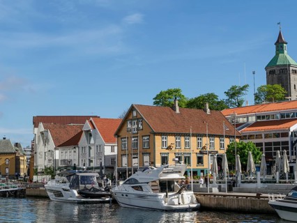 A city view by the water with yachts in the foreground and a sunny atmosphere, Stavanger, Norway,
