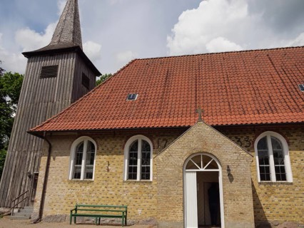 Small brick church with wooden tower and red tiled roof in summer, Kappeln, Schleswig-Holstein,