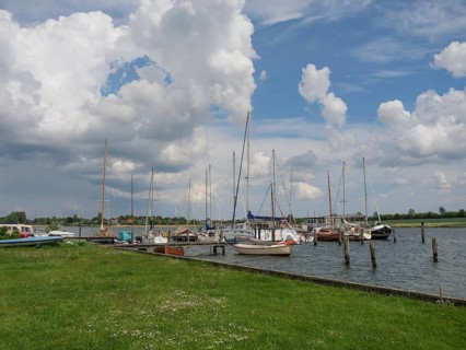 Tranquillity at the harbour where sailboats bob in the water under a cloudy sky, Arnis,