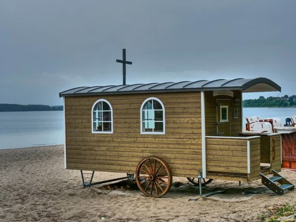 Wooden wagon on a gloomy beach, close to the water, surrounded by beach chairs, Eckernförde,