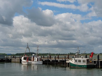 Two boats at a jetty under a partly cloudy sky, Maasholm, Schleswig-Holstein, Germany, Europe