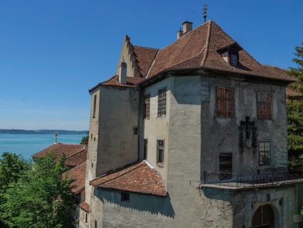 Castle overlooks a lake and is surrounded by trees, with historical details, Meersburg, Germany,