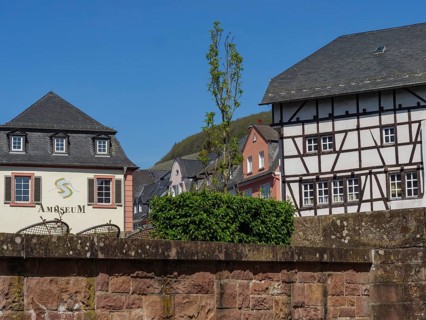 Historic buildings, including a museum and a half-timbered house, in sunny weather, Saarburg,