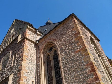 Gothic brick church under a blue sky, close-up of spire and window, Saarburg, Germany, Europe