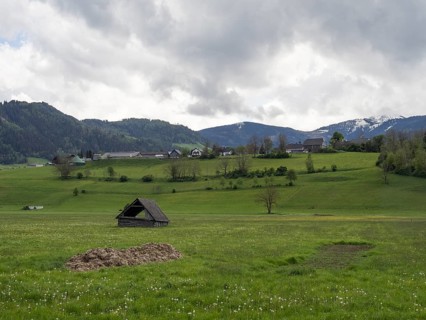 Thunderclouds over a hay barn in a meadow, mountain peak in the background, near Irdning, Ennstal,