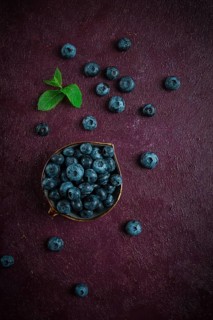 Fresh berries, Blueberries, on a maroon background, food concept, vertical, no people