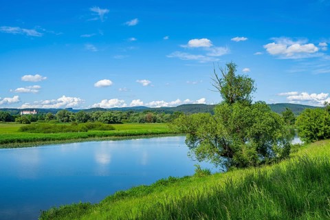 Landscape of Danubia river with reflection of the landscape and Clouds, Castle of Wörth an der