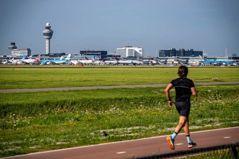 Joggers in front of the airport, aeroplanes at Amsterdam Airport Schiphol, taxiway, apron, air