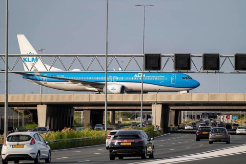 Amsterdam Schiphol Airport, KLM Boeing 737 aircraft on the taxiway, bridge over the A4 motorway,