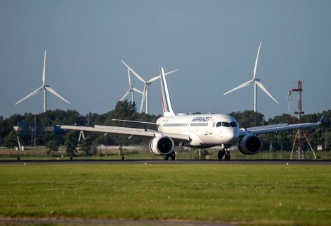 Air France aircraft landing at Amsterdam Schiphol Airport, Polderbaan, 18R/36L, wind farm in the
