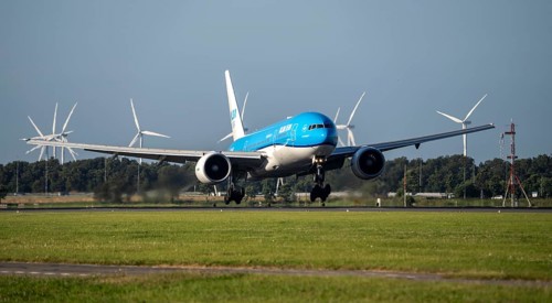 KLM aircraft landing at Amsterdam Schiphol Airport, Polderbaan, 18R/36L, wind farm in the